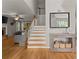 View of front stairway and entrance to a cozy living room with hardwood floors at 5510 Pilgrim Point Ext, Cumming, GA 30041