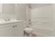Bright, all-white bathroom with shower-tub combination and vanity with storage at 2139 Jonathan Ave, Lithonia, GA 30058