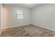 Bedroom with a bright window, neutral paint, and cozy carpet at 2139 Jonathan Ave, Lithonia, GA 30058