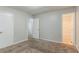 Bedroom with ensuite bathroom; neutral walls and carpet throughout at 2139 Jonathan Ave, Lithonia, GA 30058