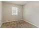 Cozy bedroom with neutral paint and carpet, featuring a bright window at 2139 Jonathan Ave, Lithonia, GA 30058