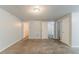 Large bedroom featuring neutral carpeting, fresh paint, and plentiful natural light at 2139 Jonathan Ave, Lithonia, GA 30058