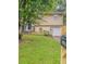 Two-story home with a well-maintained lawn, driveway, and mature trees in a suburban setting at 2139 Jonathan Ave, Lithonia, GA 30058