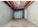 Unfinished garage with a concrete foundation, cinder block walls, and a closed garage door at 2139 Jonathan Ave, Lithonia, GA 30058