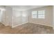A spacious, carpeted living room with two windows offering ample natural light at 2139 Jonathan Ave, Lithonia, GA 30058