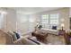Staged living room with white sofa, two chairs, side table, and a coffee table at 2139 Jonathan Ave, Lithonia, GA 30058