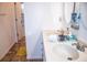 Bathroom vanity with double sinks, tiled floor, and adjacent doorway at 2650 Batavia St, East Point, GA 30344