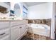 Bathroom featuring a large soaking tub and double sink vanity with great storage at 2650 Batavia St, East Point, GA 30344