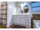 Bathroom with a double sink vanity, oval mirrors and shower-tub with curtain at 2650 Batavia St, East Point, GA 30344