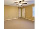 Spacious bedroom featuring a ceiling fan, neutral carpet, and ample closet space at 2650 Batavia St, East Point, GA 30344
