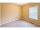 Cozy bedroom featuring neutral paint, plush carpet and a window for natural light at 2650 Batavia St, East Point, GA 30344
