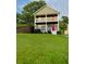 Charming two-story home featuring double porches, lush lawn, and a red front door at 2650 Batavia St, East Point, GA 30344