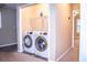 Convenient laundry closet with modern washer and dryer units and built in shelving at 2650 Batavia St, East Point, GA 30344