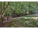 Spacious backyard with lush green grass and mature trees at 3850 Stepney Way, Cumming, GA 30041