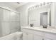 Bathroom with double sinks, granite countertops, a large mirror, and a shower with sliding glass doors at 3850 Stepney Way, Cumming, GA 30041