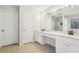 Bathroom featuring double sinks, a vanity, tile floors, and a large well-lit mirror at 3850 Stepney Way, Cumming, GA 30041