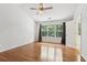 Bedroom featuring hardwood floors, ample natural light from the large window, and a ceiling fan at 3850 Stepney Way, Cumming, GA 30041