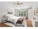 Bright bedroom features a ceiling fan, hardwood floors, and a large window offering natural light at 3850 Stepney Way, Cumming, GA 30041