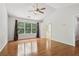Spacious bedroom with hardwood floors, ceiling fan, and a window offering ample natural light at 3850 Stepney Way, Cumming, GA 30041
