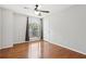 Bright bedroom with hardwood floors, a ceiling fan, and a large window at 3850 Stepney Way, Cumming, GA 30041