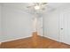 Bedroom features hardwood floors, ceiling fan, and white doors, providing a clean and inviting space at 3850 Stepney Way, Cumming, GA 30041