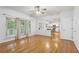 Bright living room features hardwood floors, large windows, and opens to the kitchen at 3850 Stepney Way, Cumming, GA 30041