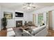 Cozy living room with fireplace, hardwood floors and large window overlooking the yard at 3850 Stepney Way, Cumming, GA 30041