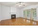 Bright living room with fireplace, hardwood floors and large windows overlooking the yard at 3850 Stepney Way, Cumming, GA 30041