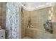 The tiled shower features a built in bench and various shower products for relaxing bathing at 695 Hiram Sudie Rd, Dallas, GA 30157