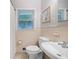 Well-lit bathroom featuring a white toilet and sink at 695 Hiram Sudie Rd, Dallas, GA 30157