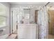 Bright bathroom with a single vanity, decorative shower curtain, and a view into an adjacent room at 695 Hiram Sudie Rd, Dallas, GA 30157