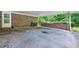 Covered carport area featuring a brick wall with space for a grill, offering protection from the elements at 695 Hiram Sudie Rd, Dallas, GA 30157