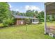 Brick home exterior with a screened-in porch surrounded by greenery, creating a charming curb appeal at 695 Hiram Sudie Rd, Dallas, GA 30157