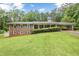 Traditional brick home featuring a beautiful, verdant lawn with ample space and shade trees at 695 Hiram Sudie Rd, Dallas, GA 30157
