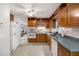 Traditional kitchen featuring wood cabinets, tile floors and white appliances at 695 Hiram Sudie Rd, Dallas, GA 30157
