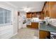 Traditional kitchen featuring wood cabinets, tile floors and white appliances at 695 Hiram Sudie Rd, Dallas, GA 30157