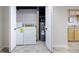 Enclosed laundry area with washer, dryer, and adjacent hot water tank near utility sink at 695 Hiram Sudie Rd, Dallas, GA 30157