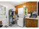 Bright laundry room with stackable washer and dryer and storage cabinets at 695 Hiram Sudie Rd, Dallas, GA 30157