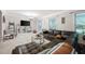 Spacious living room with a cozy sectional, decorative shelving, and natural light at 695 Hiram Sudie Rd, Dallas, GA 30157