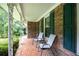 Inviting porch with brick flooring, seating, and green shutters, perfect for relaxation at 695 Hiram Sudie Rd, Dallas, GA 30157