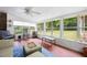 Bright sunroom with patterned tile, comfortable seating, and views of the lush backyard at 695 Hiram Sudie Rd, Dallas, GA 30157