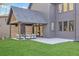Backyard features covered patio with outdoor seating and well manicured yard at 115 Nova Lane, Roswell, GA 30075
