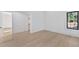 Bedroom with hardwood floors, a window with black trim and entry to a walk-in closet at 115 Nova Lane, Roswell, GA 30075