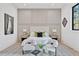 Cozy bedroom showcases neutral tones, stylish furnishings, and natural light from the window at 115 Nova Lane, Roswell, GA 30075