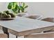 Close-up of dining table in bright dining room with soft chairs and mossy spheres centerpiece at 115 Nova Lane, Roswell, GA 30075