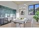 Bright dining room with statement lighting, a wet bar and large black frame windows at 115 Nova Lane, Roswell, GA 30075