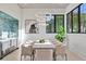 Bright dining room with statement lighting, a wet bar and large black frame windows at 115 Nova Lane, Roswell, GA 30075