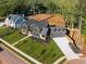 Stunning new construction home with manicured lawn, lush landscaping, and three-car garage at 115 Nova Lane, Roswell, GA 30075