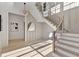 Elegant entryway with a staircase, light hardwood floors, decorative mirror and paneling at 115 Nova Lane, Roswell, GA 30075