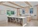 Gourmet kitchen with island seating, stone countertops, wooden beams and modern lighting at 115 Nova Lane, Roswell, GA 30075